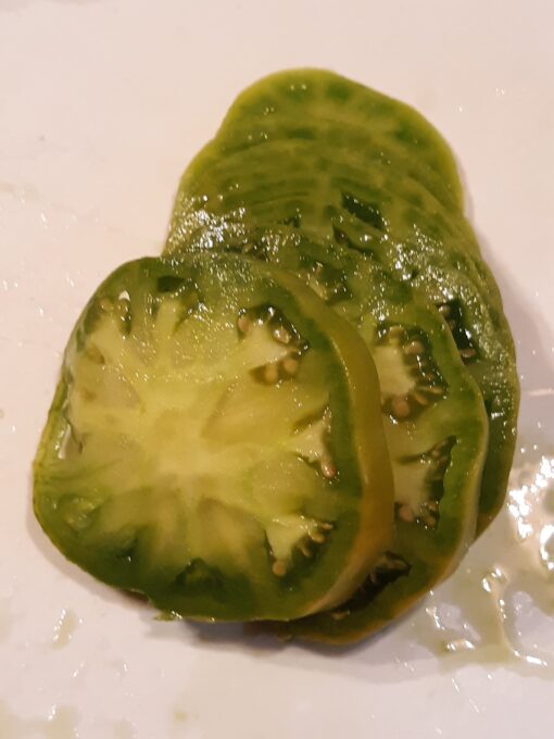 Juicy slices of Aunt Ruby's German Green Tomato on a plate.