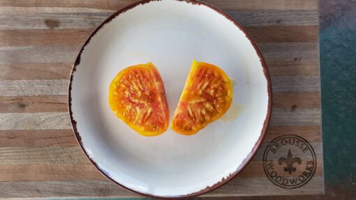 Marbled reddish orange and yellow Pineapple Tomato slices.