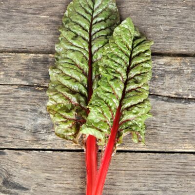 Chard Ruby Red on a wooden surface.