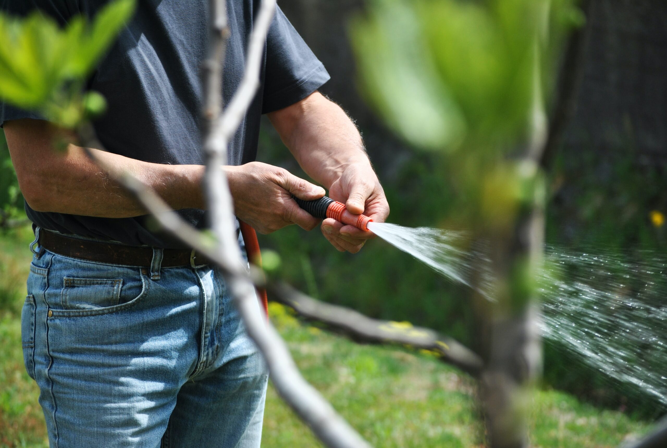 Man using water hose.