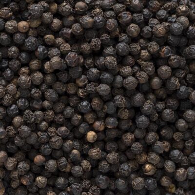 Dark black peppercorns of various shades.