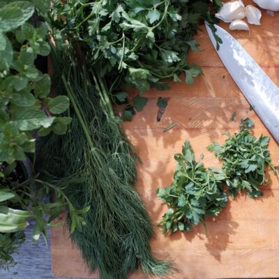 Fresh herbs on a cutting board.