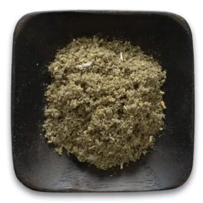 Rubbed sage leaf in a dark colored dish.