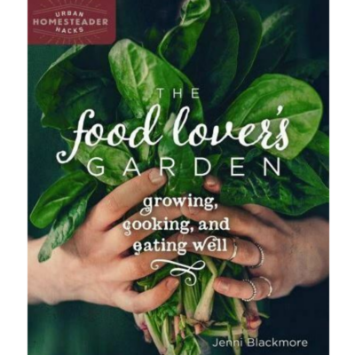The Food Lover's Garden front cover with a handful of greens.