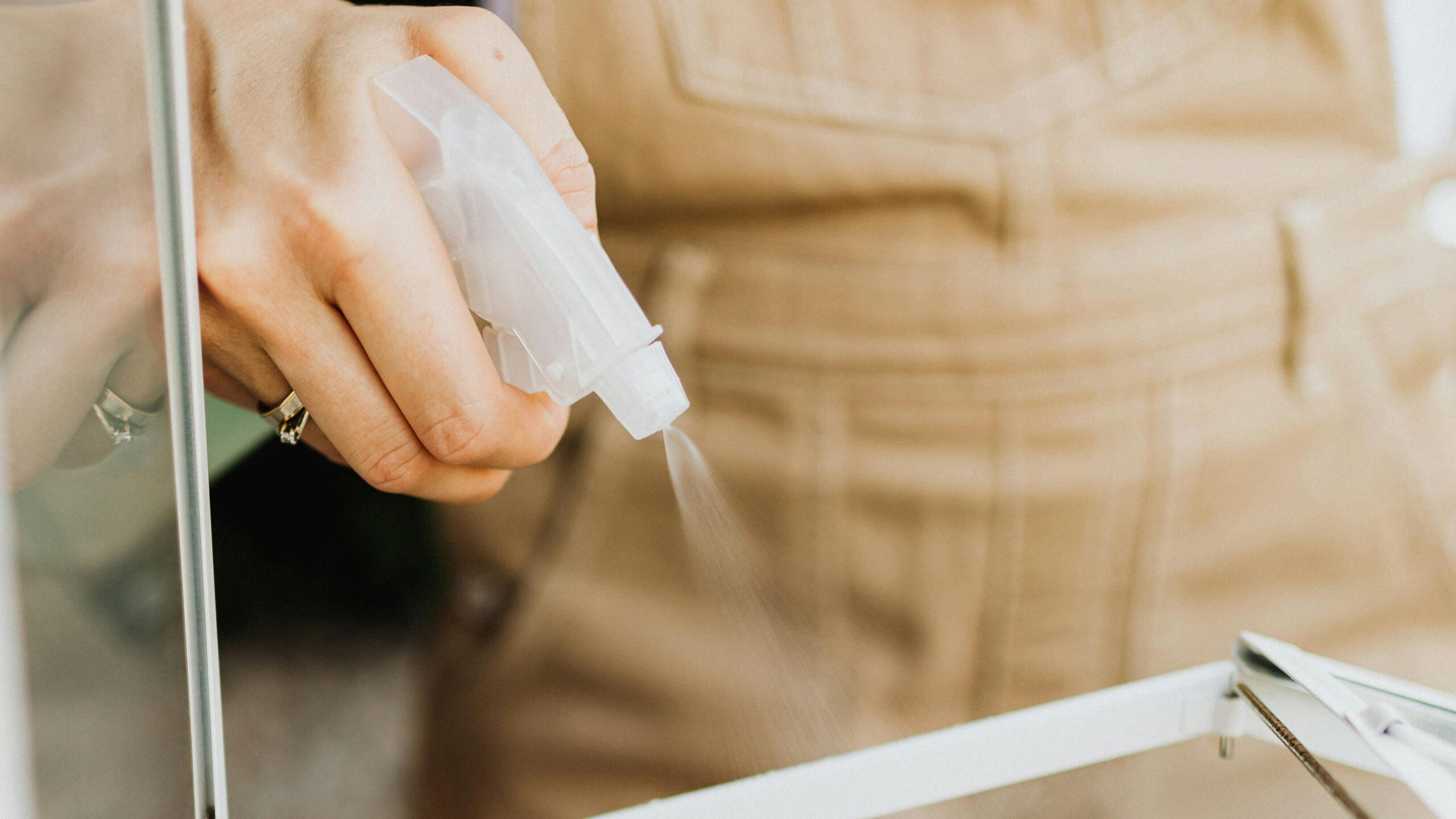 Spraying liquid from a spray bottle.