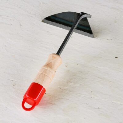 A Gama Hoe 11" with a black metal head and a wooden handle with a red grip, lying on a white textured surface.