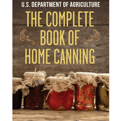 Cover of "The Complete Book of Home Canning USDA" featuring jars of preserved vegetables with burlap covers, set against a wooden background.